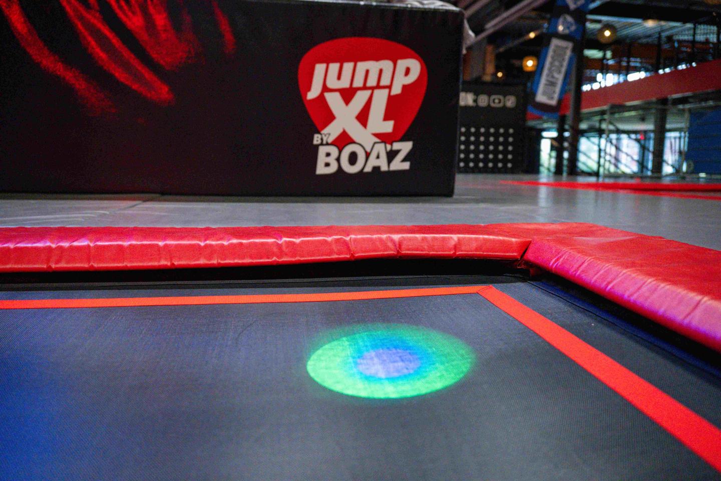 Interactieve lichtspot onder trampoline als onderdeel van Tag & Jump in trampolinepark.